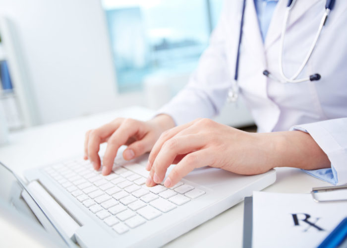 Modern medical person inputting diagnosis into an online data base